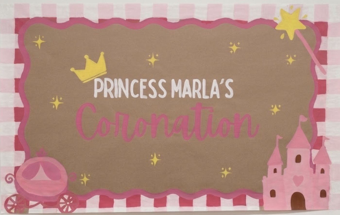 Hand-painted banner reading Princess Marla's Coronation, with a crown, castle, carriage and pink striped border