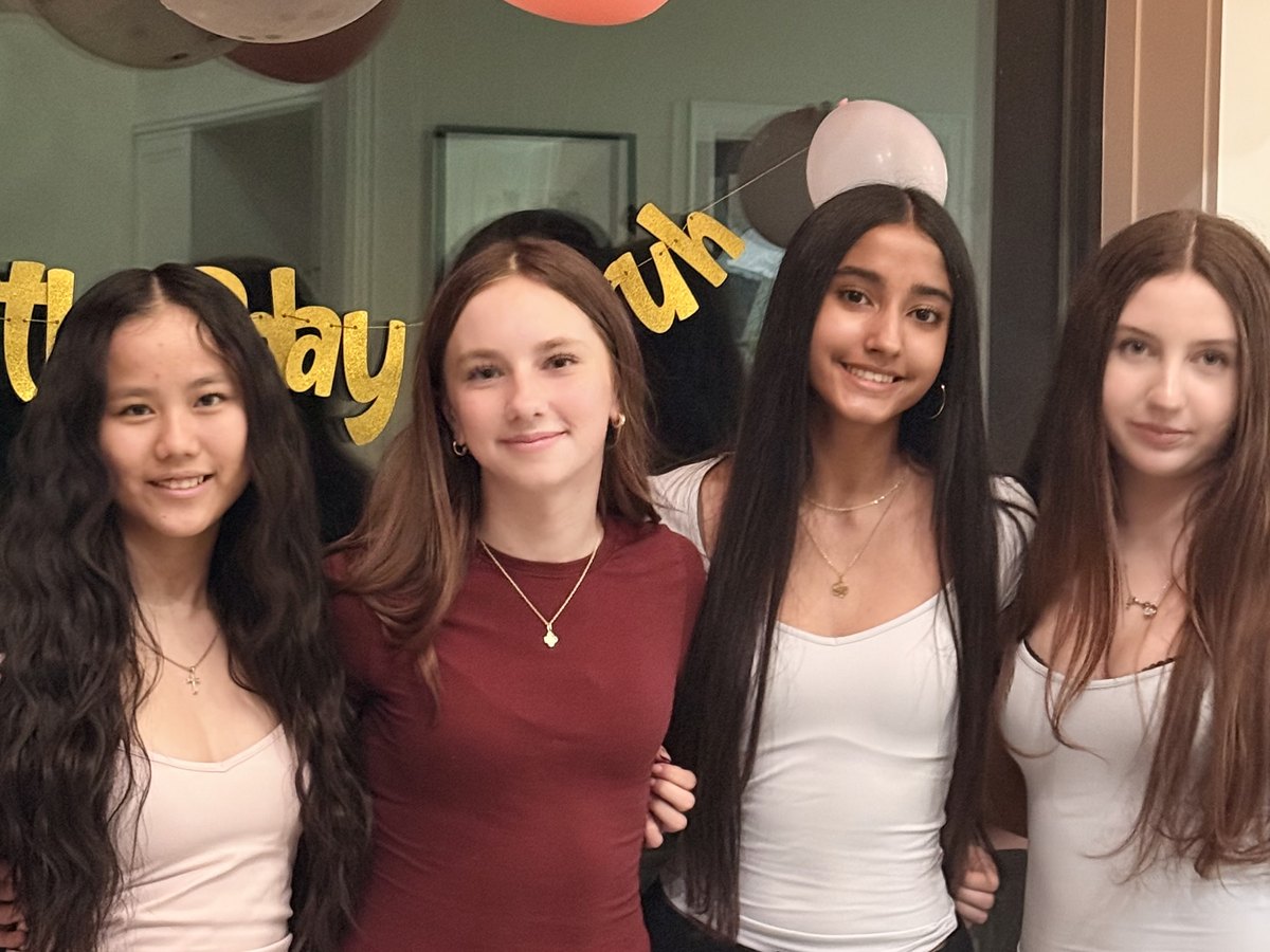 The four teenage artists behind Made For Moments Banners, standing together at a birthday party